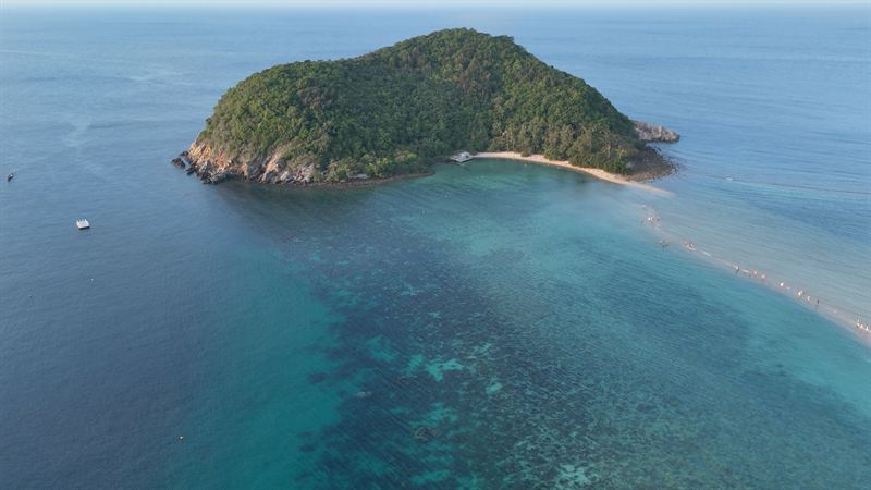 Koh Ma desde el aire, unida a Koh Phangan por una lengua de arena, con el arrecife visible en el agua clara.