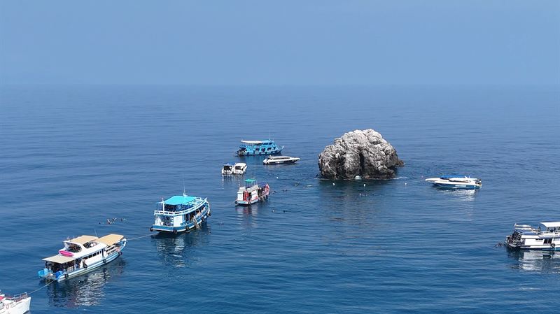 Sail Rock seen from above, rising out of the blue Gulf of Thailand.